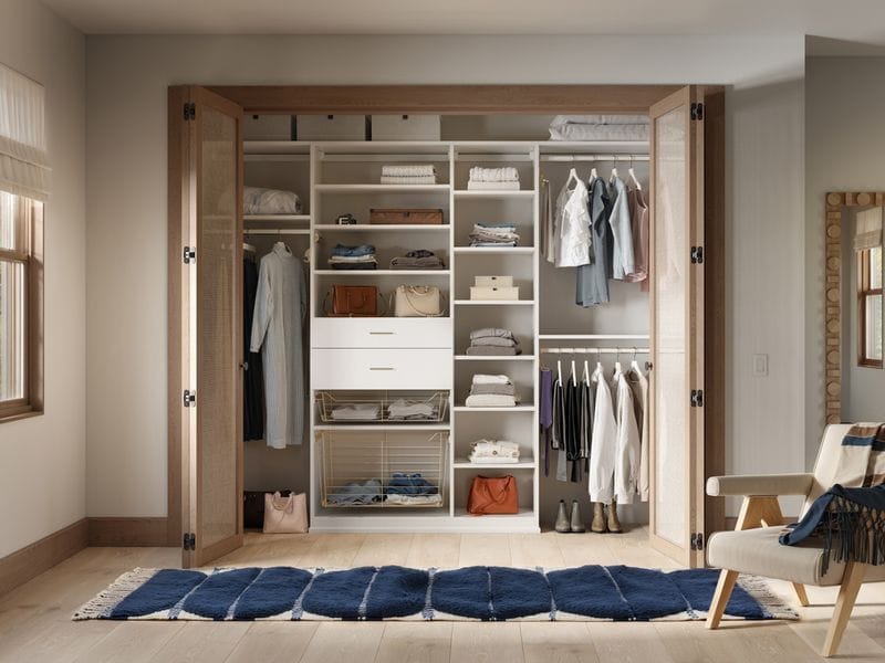 To floor reach in closet designed with custom shelving and drawers by California Closets
